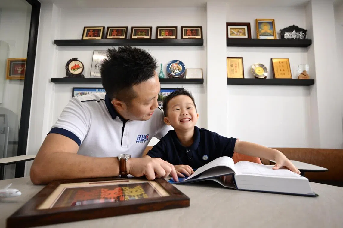 Eldred Wee exposing his son Eden to Hainanese language and culture at the Hainan Business Chamber.