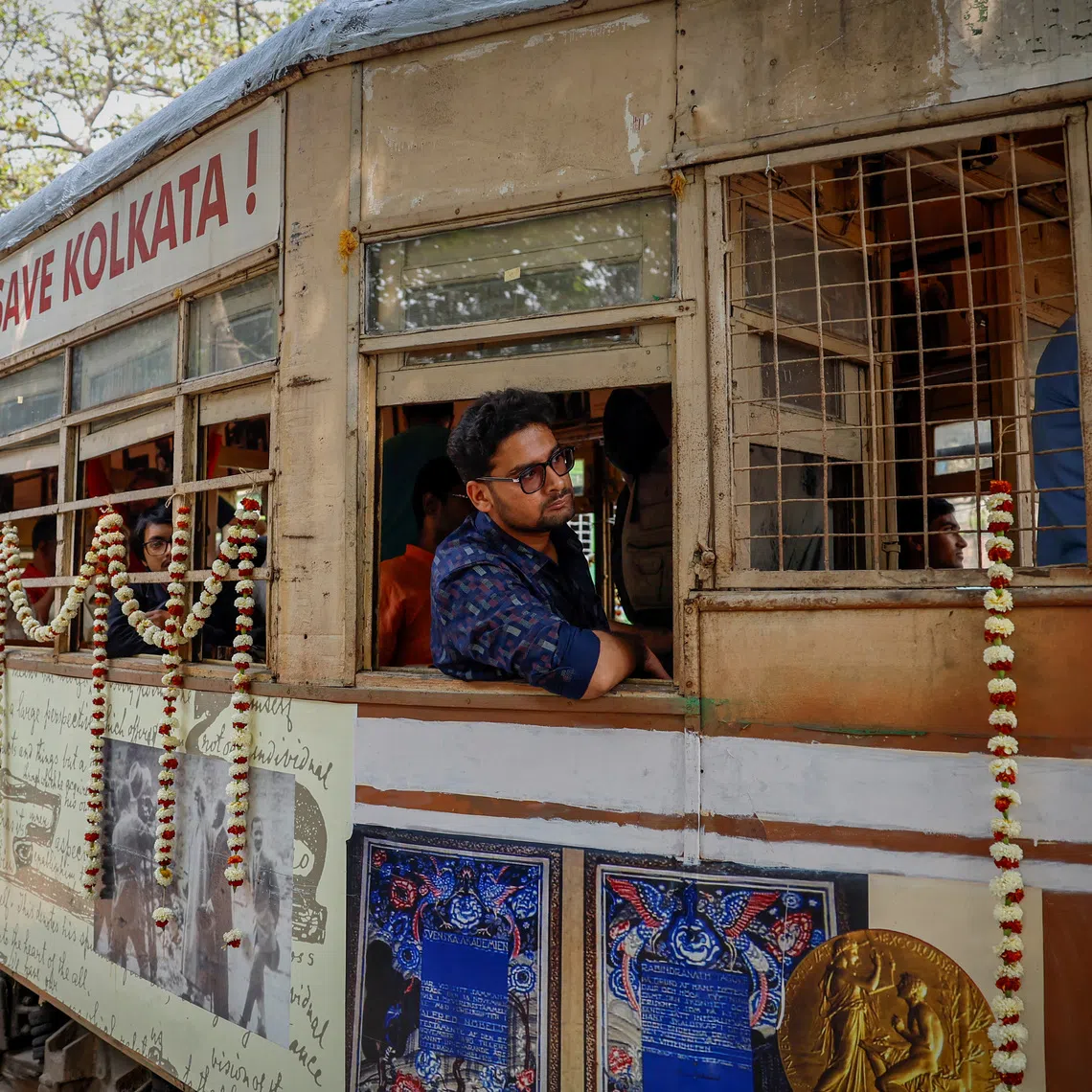 Passengers sit inside a decorated tram during the 152nd anniversary celebrations of trams in Kolkata, India, February 24, 2025. REUTERS/Sahiba Chawdhary