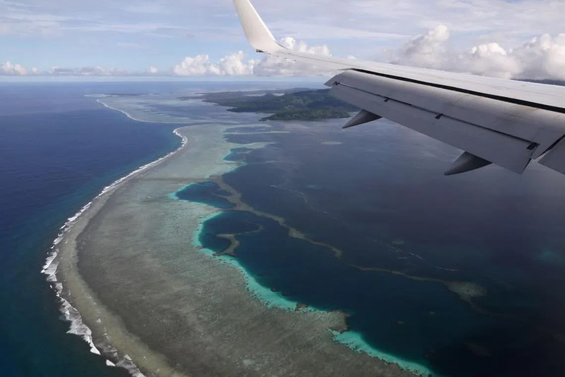 FILE PHOTO: A plane carrying then-U.S. Secretary of State Mike Pompeo makes its landing approach on Pohnpei International Airport in Kolonia, Federated States of Micronesia August 5, 2019. REUTERS/Jonathan Ernst/File Photo