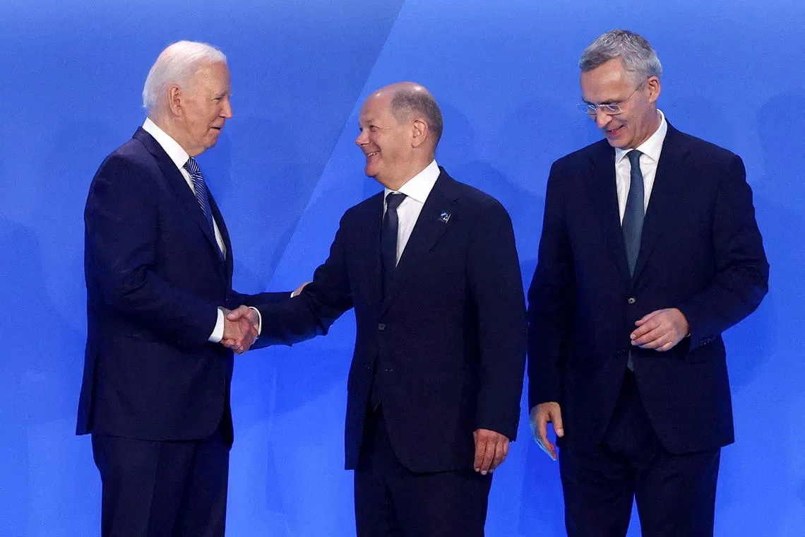 FILE PHOTO: German Chancellor Olaf Scholz is greeted by U.S. President Joe Biden and NATO Secretary General Jens Stoltenberg during NATO's 75th anniversary summit in Washington, U.S., July 10, 2024. REUTERS/Yves Herman/File Photo