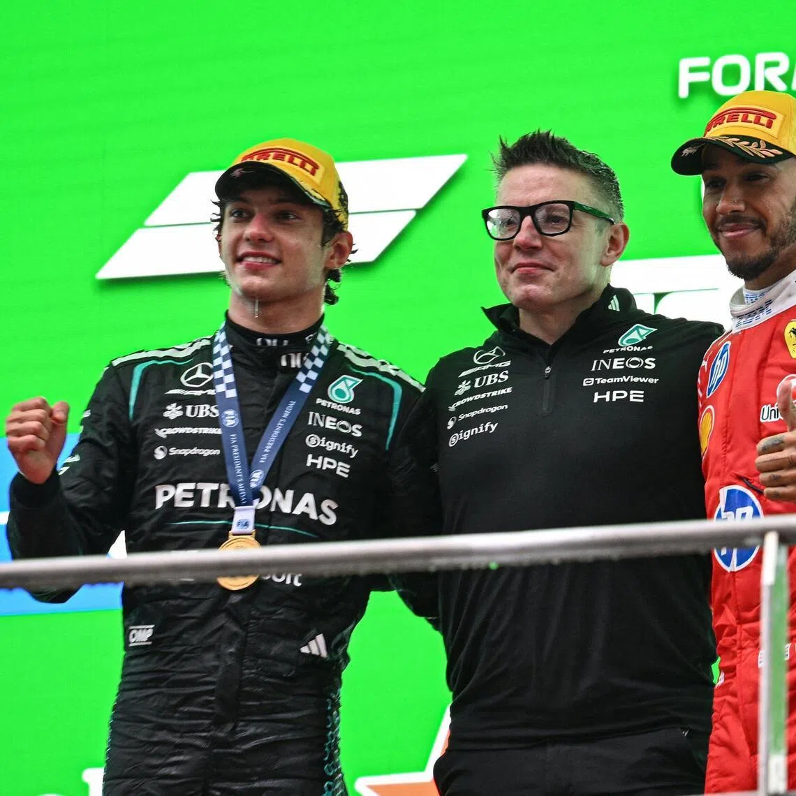 From left: Chinese Grand Prix winner Kimi Antonelli with Mercedes race engineer Peter Bonnington and Ferrari's Lewis Hamilton on the podium on March 15.