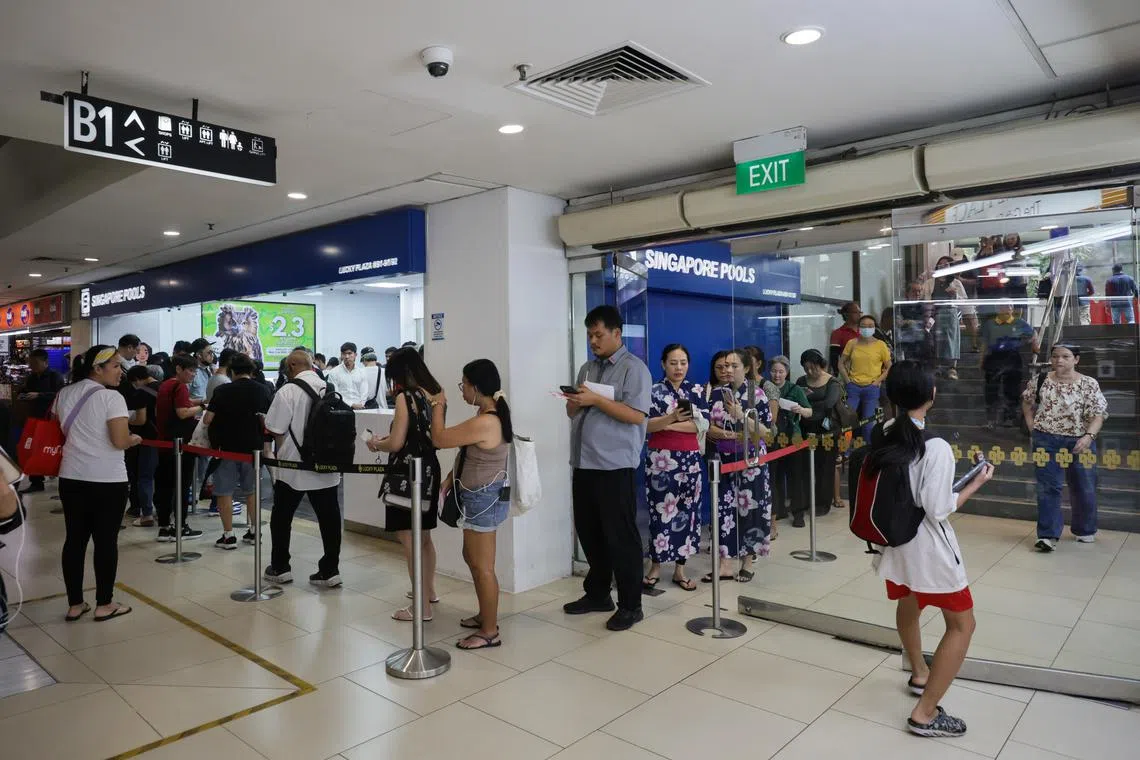 A queue at the Singapore Pools branch in Lucky Plaza on June 19.