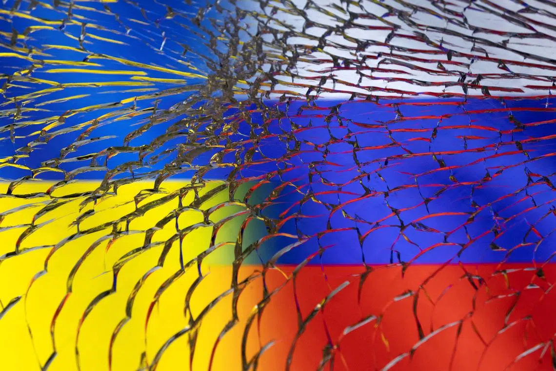 FILE PHOTO: Ukraine and Russian flags are seen through broken glass in this illustration taken March 1, 2022. REUTERS/Dado Ruvic/Illustration/File photo