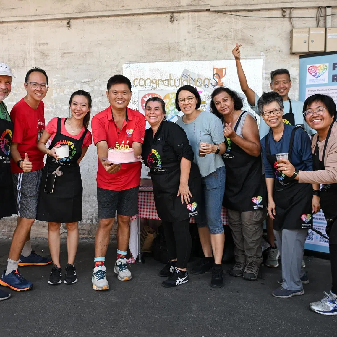 Fridge Restock Community founder Daniel Yap (fourth left) and his group of volunteers rescuing unsellable fruits and vegetables to be distributed to residents of Boon Lay Drive on Dec 5, 2025. 