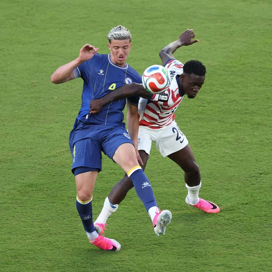 USA’s Folarin Balogun (right) was sent off after being judged to have stamped on the back of Bosnia and Herzegovina defender Tarik Muharemovic’s foot.