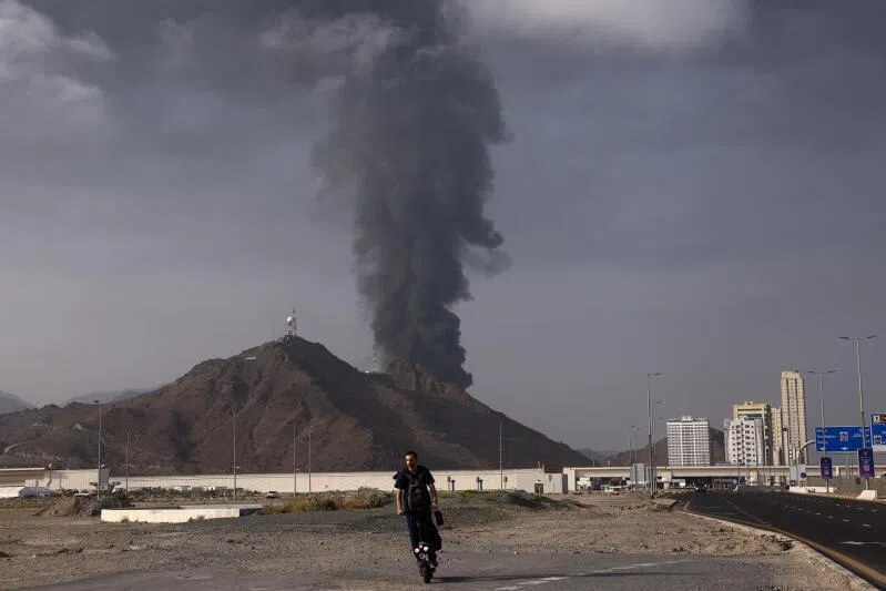 Smoke rising in the Fujairah oil industry zone after debris from an intercepted drone set off a fire.