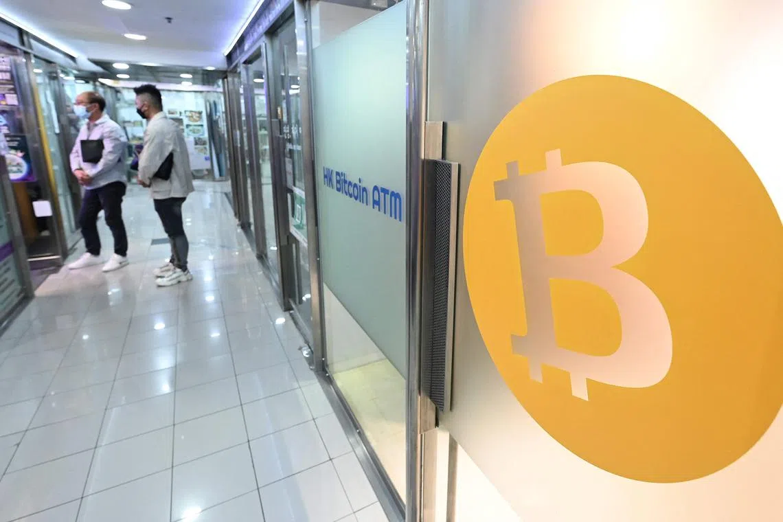 A Bitcoin logo on an ATM in a mall in Hong Kong on Nov 1, 2022, Hong Kong is l is preparing to issue more licences for crypto firms. and exploring whether to legalise crypto trading by retail investors. 