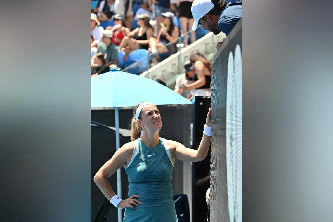 Belarus' Victoria Azarenka consults with her coach Maxime Tchoutakian at the court-side coaching pod while playing against Italy's Lucia Bronzetti.