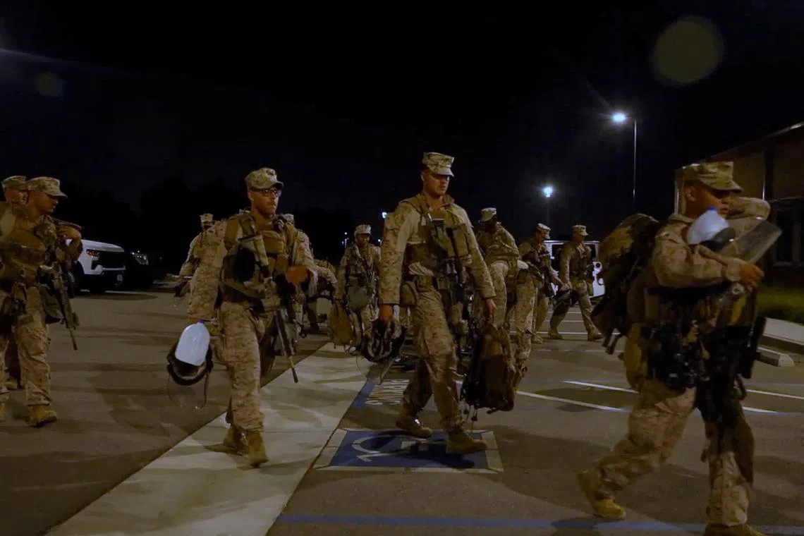 U.S. Marines carry their packs, as protests against federal immigration sweeps continue, in greater Los Angeles, California, U.S., June 9, 2025, in this screen grab taken from a handout video. DVIDS/Handout via REUTERS    THIS IMAGE HAS BEEN SUPPLIED BY A THIRD PARTY