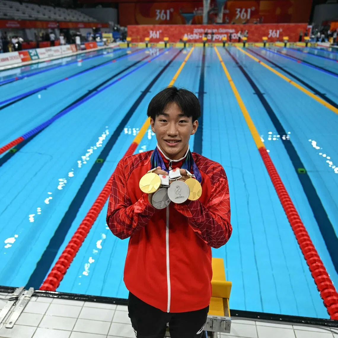 Japan’s Shin Ohashi, who smashed the men’s 200m breaststroke world record on Sept 24, with his medals after the Asian Games swimming events on Sept 25.