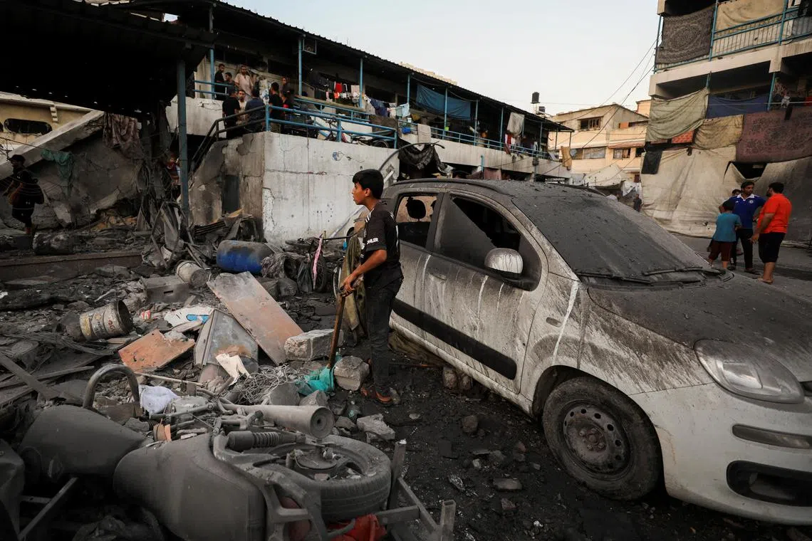 A damaged vehicle is seen at a UN-run school sheltering displaced people, following an Israeli strike in Gaza City, in July 2024.