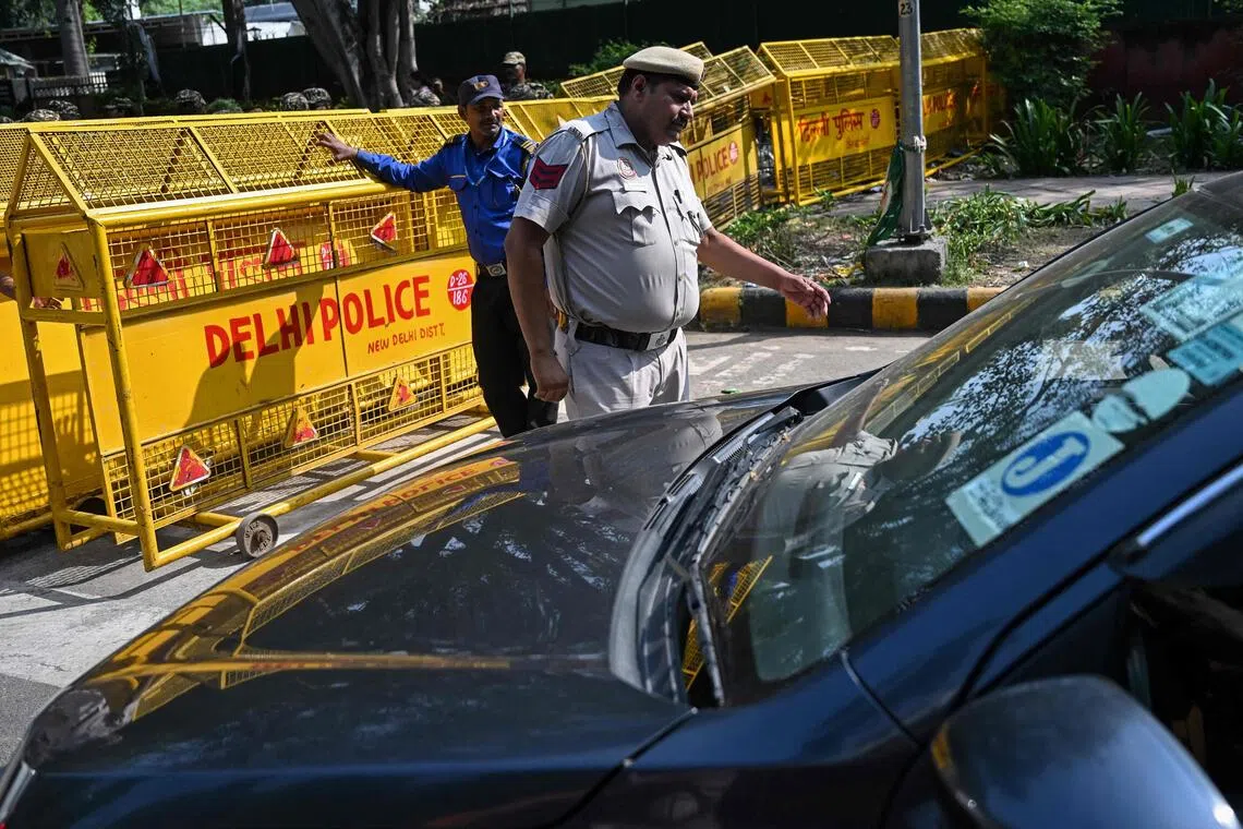 A police officer inspects vehicles near the Jantar Mantar protest site in New Delhi on Oct 13.