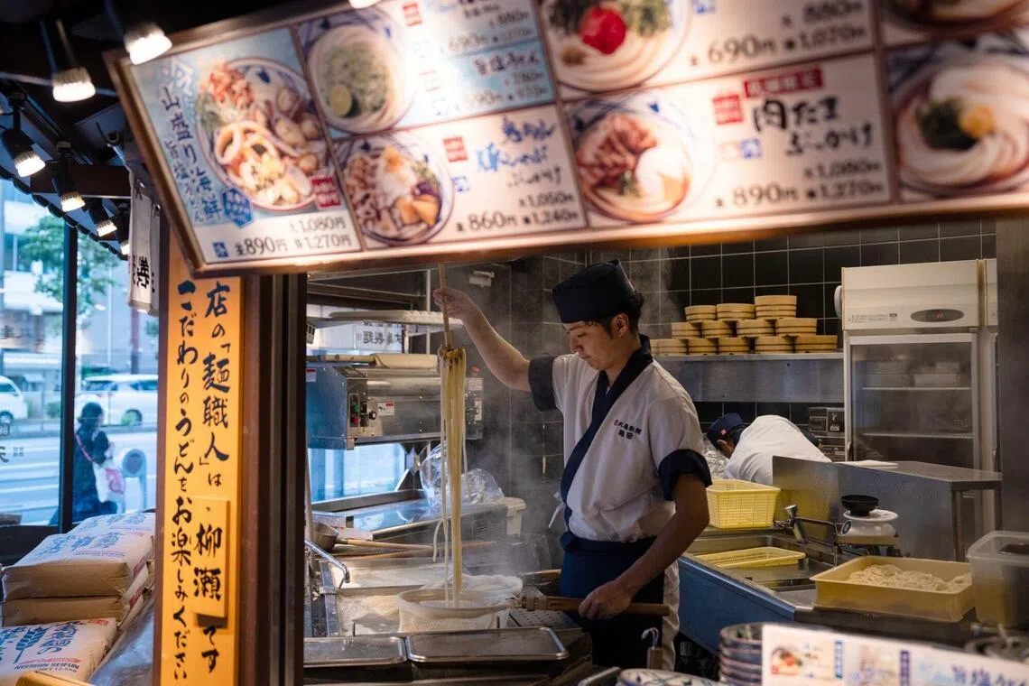 An employee prepares udon noodles at a Marugame Seimen restaurant in Tokyo, Japan, on Monday, July 27, 2026. Takaya Awata, founder and chief executive officer of Toridoll Holdings Corp., wants the company, with almost ¥280 billion ($1.8 billion) in annual revenue, to join the trillion-yen ranks of the world’s largest fast-food chains, primarily by growing its flagship Marugame Udon brand. Photographer: Louise Delmotte/Bloomberg