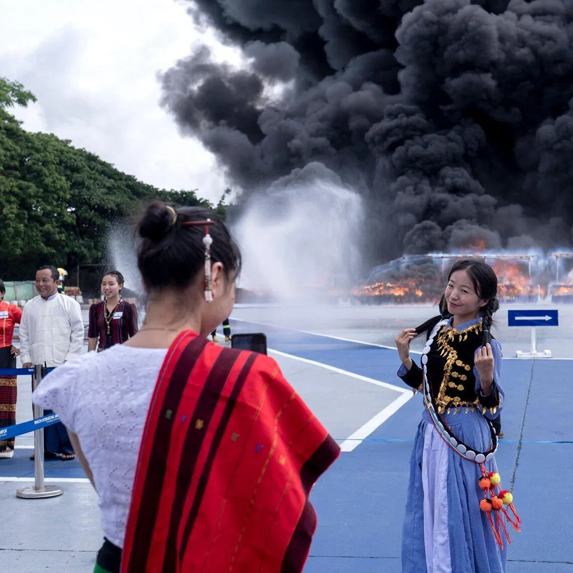 People take photos as they attend a destruction ceremony of seized illegal drugs to mark the United Nations’ “International Day against Drug Abuse and Illicit Trafficking” in Yangon on June 26.