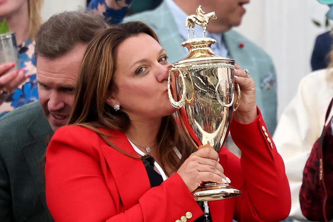 LOUISVILLE, KENTUCKY - MAY 02: Cherie DeVaux trainer of Golden Tempo #19, is the first female trainer to win the Kentucky Derby, celebrates with the trophy in the winner's circle following the 152nd running of the Kentucky Derby at Churchill Downs on May 02, 2026 in Louisville, Kentucky.   Michael Reaves/Getty Images/AFP (Photo by Michael Reaves / GETTY IMAGES NORTH AMERICA / Getty Images via AFP)