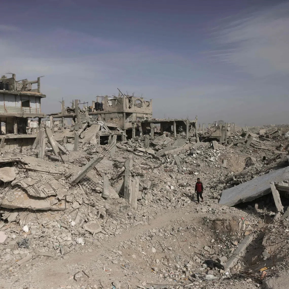 A Palestinian man on the rubble of destroyed buildings in Khan Yunis, in the southern Gaza Strip on Dec 13.