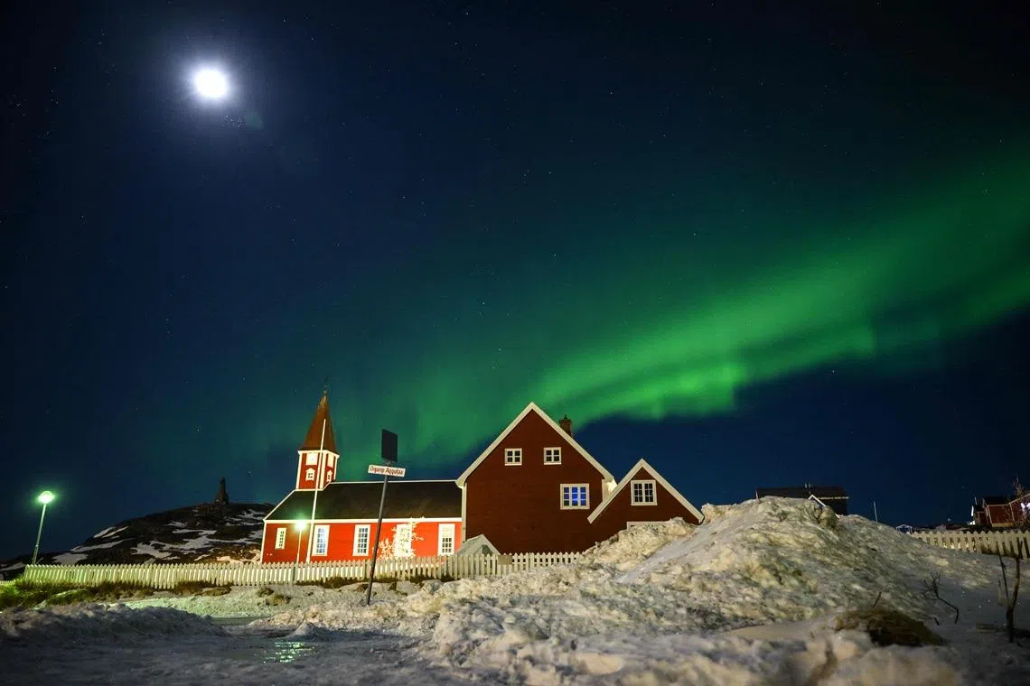 Northern lights (Aurora Borealis) glowing above a small church in the city of Nuuk, Greenland on Jan 28, 2026. 