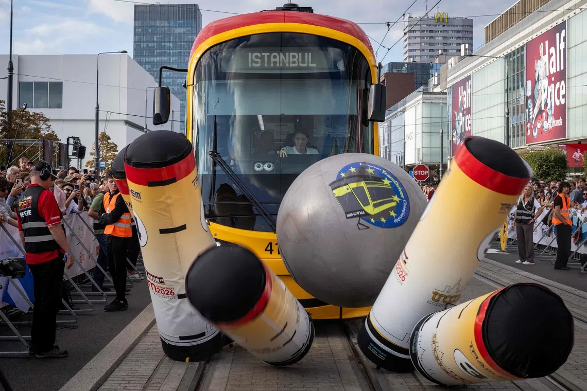 TOPSHOT - The tram of the Turkey team from Istanbul competes during the 12th European Tram Driver Championship in front of Palace of Culture and Science on Marszalkowska street in Warsaw's downtown, on September 19, 2026. 26 teams – each consisting of a female and a male tram driver, from 25 cities and 24 European countries, plus one guest team from Melbourne, Australia – show off their driving skills in a series of challenging competitions that test their precision, concentration, feel for the vehicle, and control of the tram. (Photo by Wojtek RADWANSKI / AFP)