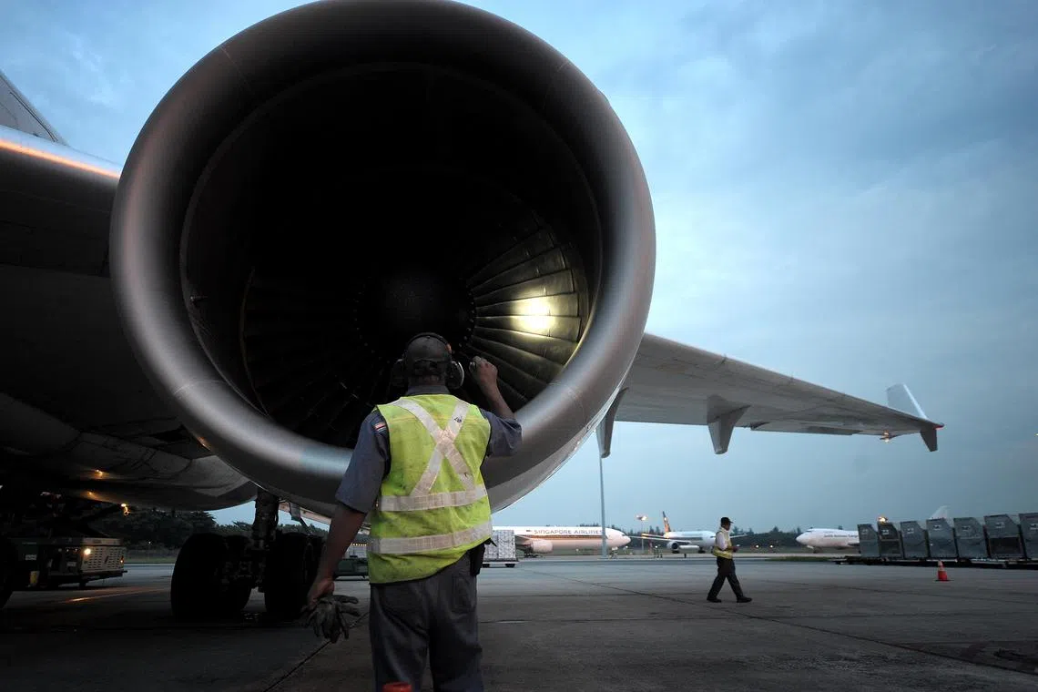 A ground handler inspects the engines of a cargo aircraft at the cargo terminal at Changi Airport. As a routine measure, the engines of all landed aircrafts are checked prior to the next flight for safety. The formation of ice in the engines are one of the many other things ground handlers look out for.