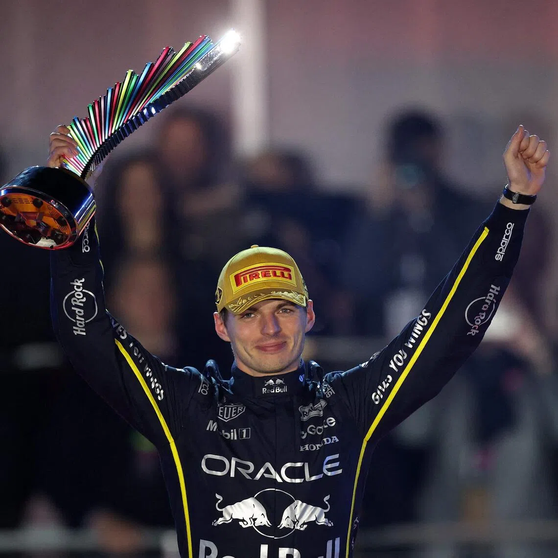 Red Bull's Max Verstappen lifting his trophy in triumph after winning the Las Vegas Grand Prix on Nov 22.