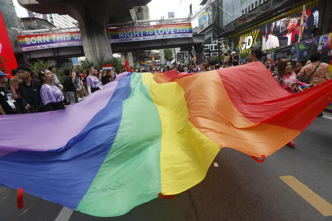 epa12149225 People carry a large rainbow colored flag as they take part in the Bangkok Pride Parade 2025 to celebrate Pride Month in Bangkok, Thailand, 01 June 2025. Thousands of people joined the parade along the main road of a major business district. Pride Month is celebrated worldwide every June to commemorate the 1969 Stonewall uprising and to raise awareness and promote equal rights for the Lesbian, Gay, Bisexual, Transgender, and Queer (LGBTQ) community.  EPA-EFE/NARONG SANGNAK
