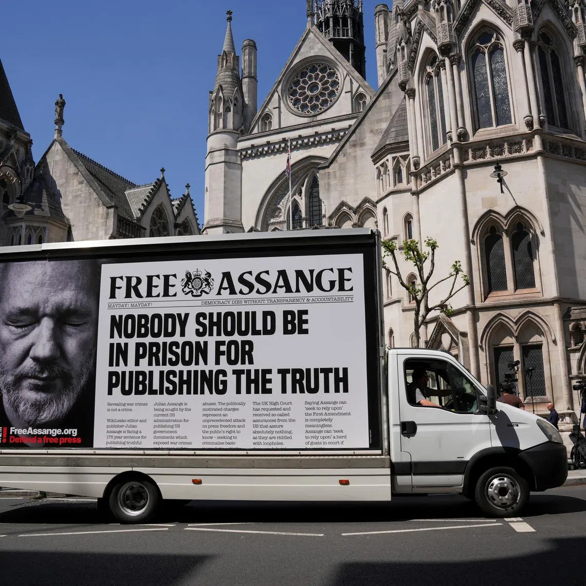 FILE PHOTO: A car with a message in support of WikiLeaks founder Julian Assange drives in front of the High Court, on the day of an extradition hearing of Julian Assange, in London, Britain, May 20, 2024. REUTERS/Maja Smiejkowska/File Photo