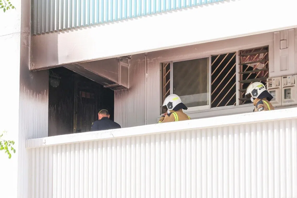 Police and SCDF officers entering the affected unit at Block 128 Yishun Street 11 on Nov 7.