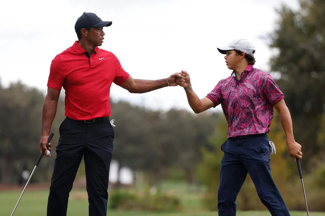 Tiger Woods and son Charlie on the 13th green during the final round of the PNC Championship at The Ritz-Carlton Golf Club in Orlando.
