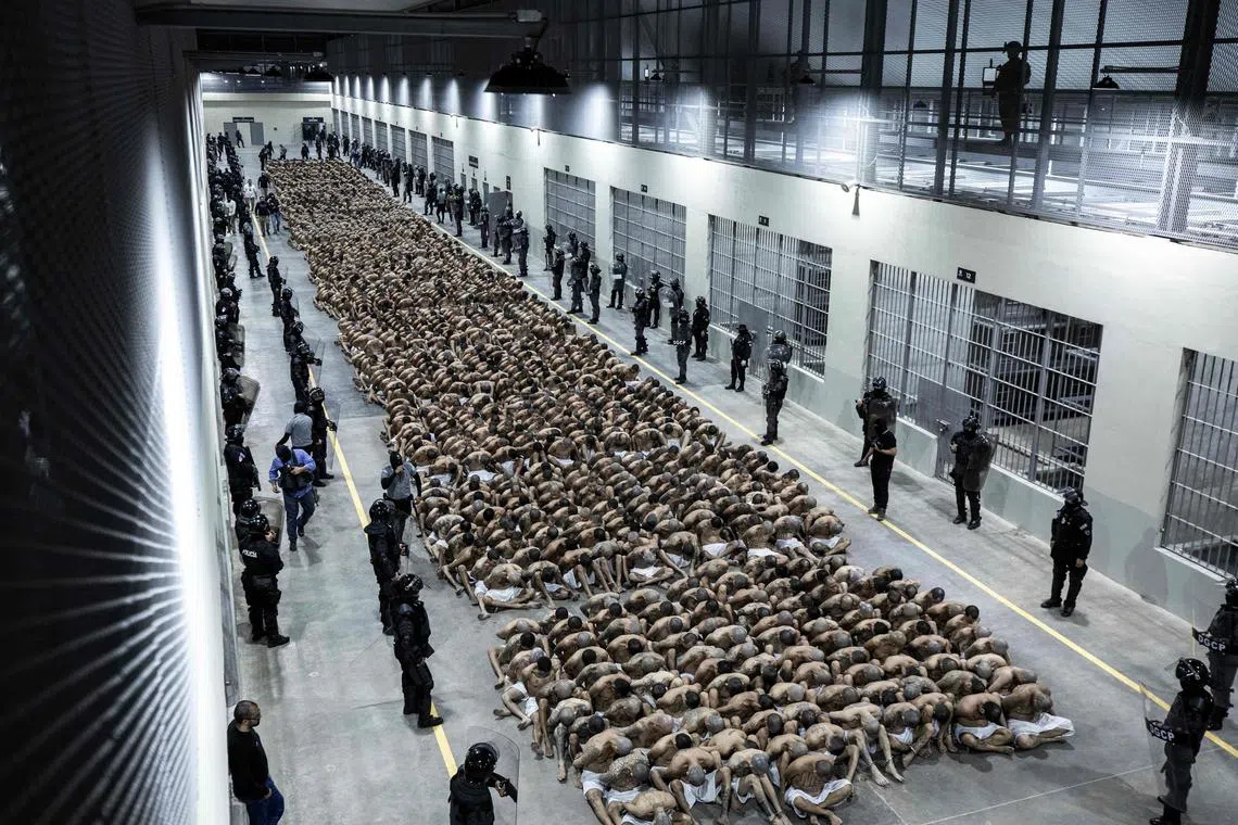 This handout picture released by the El Salvador's Presidency shows the second arrival of inmates belonging to the MS-13 and 18 gangs to the new prison "Terrorist Confinement Centre" (CECOT) in Tecoluca, 74 km southeast of San Salvador, on March 15, 2023. The decision to bring thousands of suspected gang members imprisoned in El Salvador to collective trials was rejected by human rights organizations and judges, who affirm that it is a populist measure to favor the re-election of President Nayib Bukele. (Photo by EL SALVADOR'S PRESIDENCY PRESS OFFICE / AFP) / RESTRICTED TO EDITORIAL USE - MANDATORY CREDIT "AFP PHOTO / EL SALVADOR'S PRESIDENCY PRESS OFFICE" - NO MARKETING NO ADVERTISING CAMPAIGNS - DISTRIBUTED AS A SERVICE TO CLIENTS
