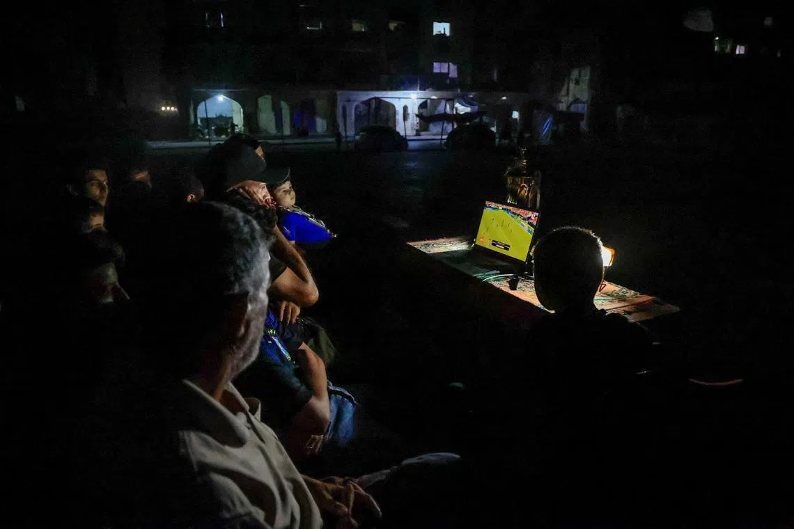 Gazans displaced by war watch World Cup from the ruins