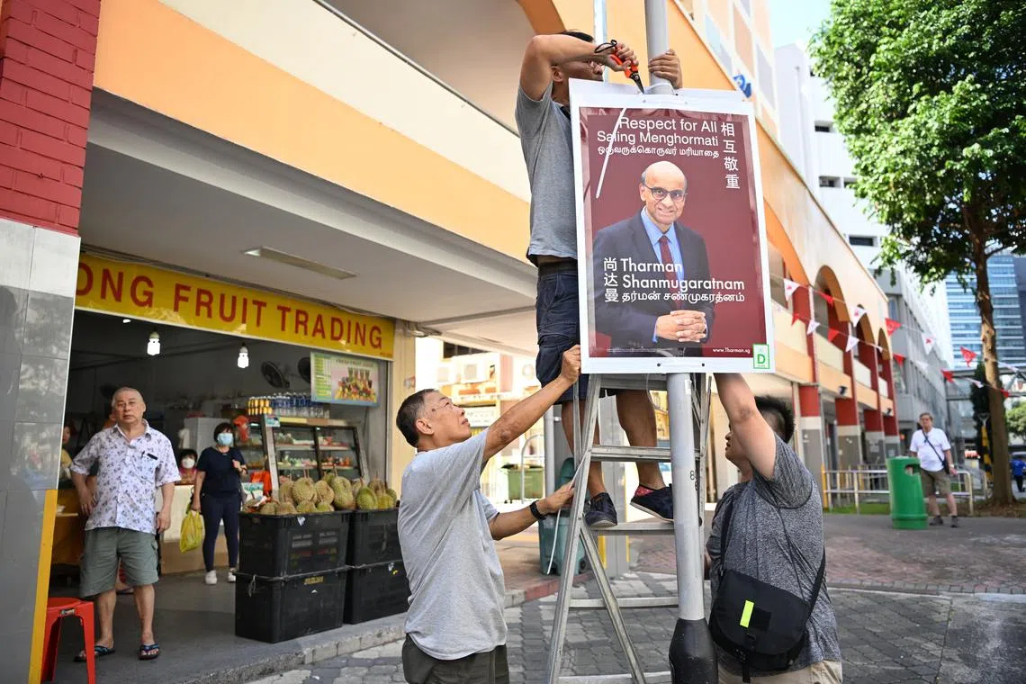 Posters of presidential candidate Tharman Shanmugaratnam being put up at the Jalan Besar area.
