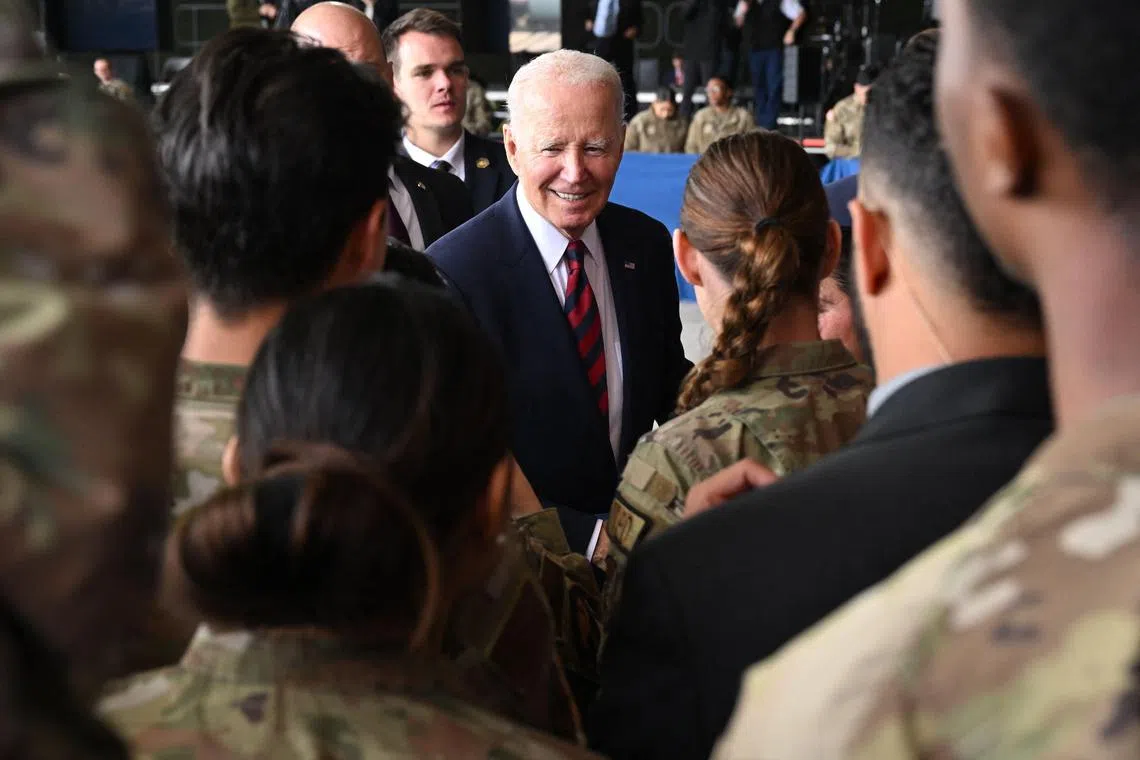 TOPSHOT - US President Joe Biden greets service members after delivering remarks to service members, first responders, and their families on the 22nd anniversary of the September 11, 2001, terrorist attacks, at Joint Base Elmendorf-Richardson in Anchorage, Alaska, on September 11, 2023. (Photo by SAUL LOEB / AFP)