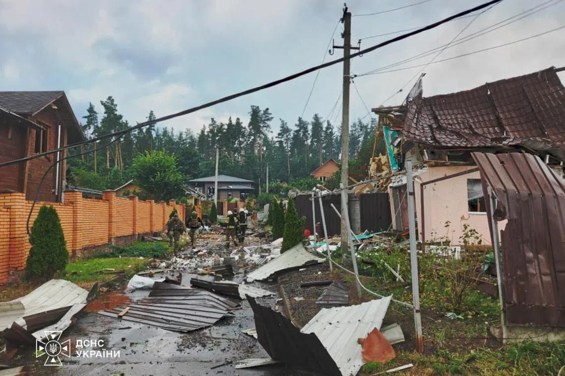 Emergency employees work at the site of a Russian missile strikes, amid Russia’s attack on Ukraine, in Kyiv region, Ukraine on July 24.