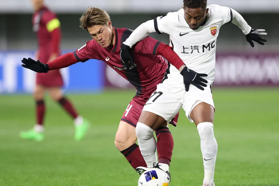 Vissel Kobe's Gotoku Sakai (left) fights for the ball with Shanghai's Brazilian player Gabrielzinho in their AFC Champions League match in Kobe on Feb 11, 2025. The Japanese champions romped into the last 16 with a 4-0 victory.
