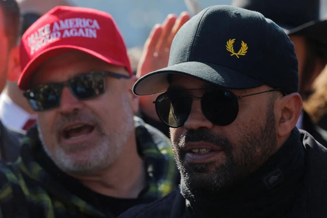 FILE PHOTO: Former far-right Proud Boys leader Joseph Biggs and former national chairman of the Proud Boys Henry \"Enrique\" Tarrio speak to reporters during a press availability outside the Capitol in Washington, D.C., U.S., February 21, 2025.   REUTERS/Brian Snyder/File Photo