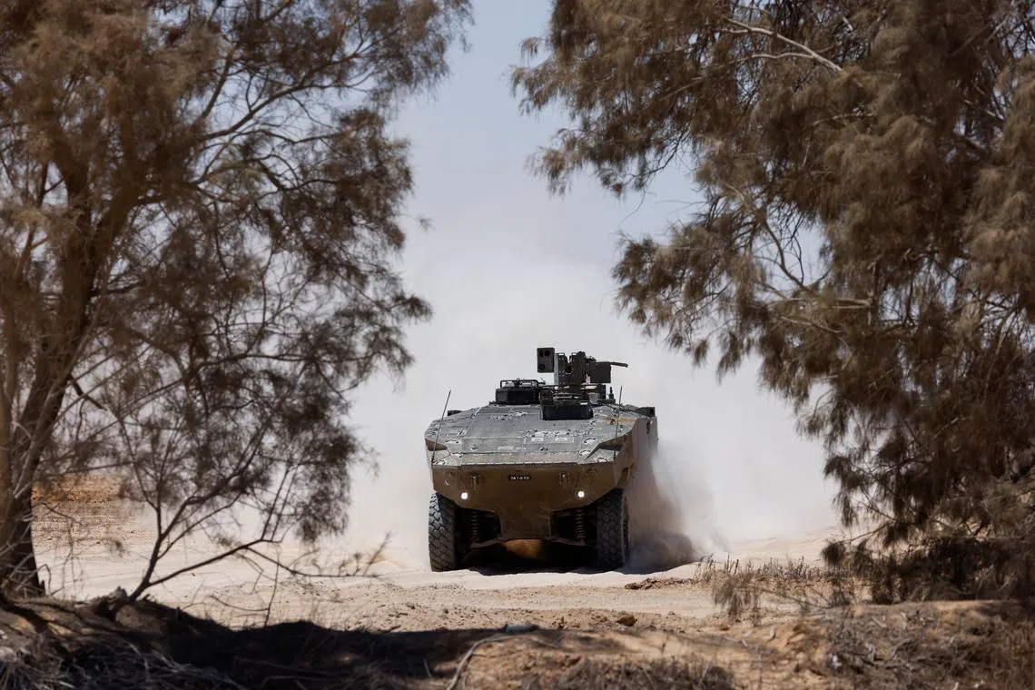 An Israeli military vehicle manoeuvres near the Israel-Gaza border, amid the Israel-Hamas conflict, in Israel, July 10, 2024. REUTERS/Amir Cohen