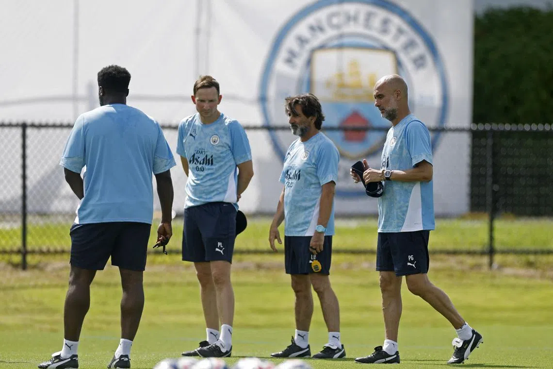 Manchester City manager Pep Guardiola and his staff overseeing training ahead of the Club World Cup.