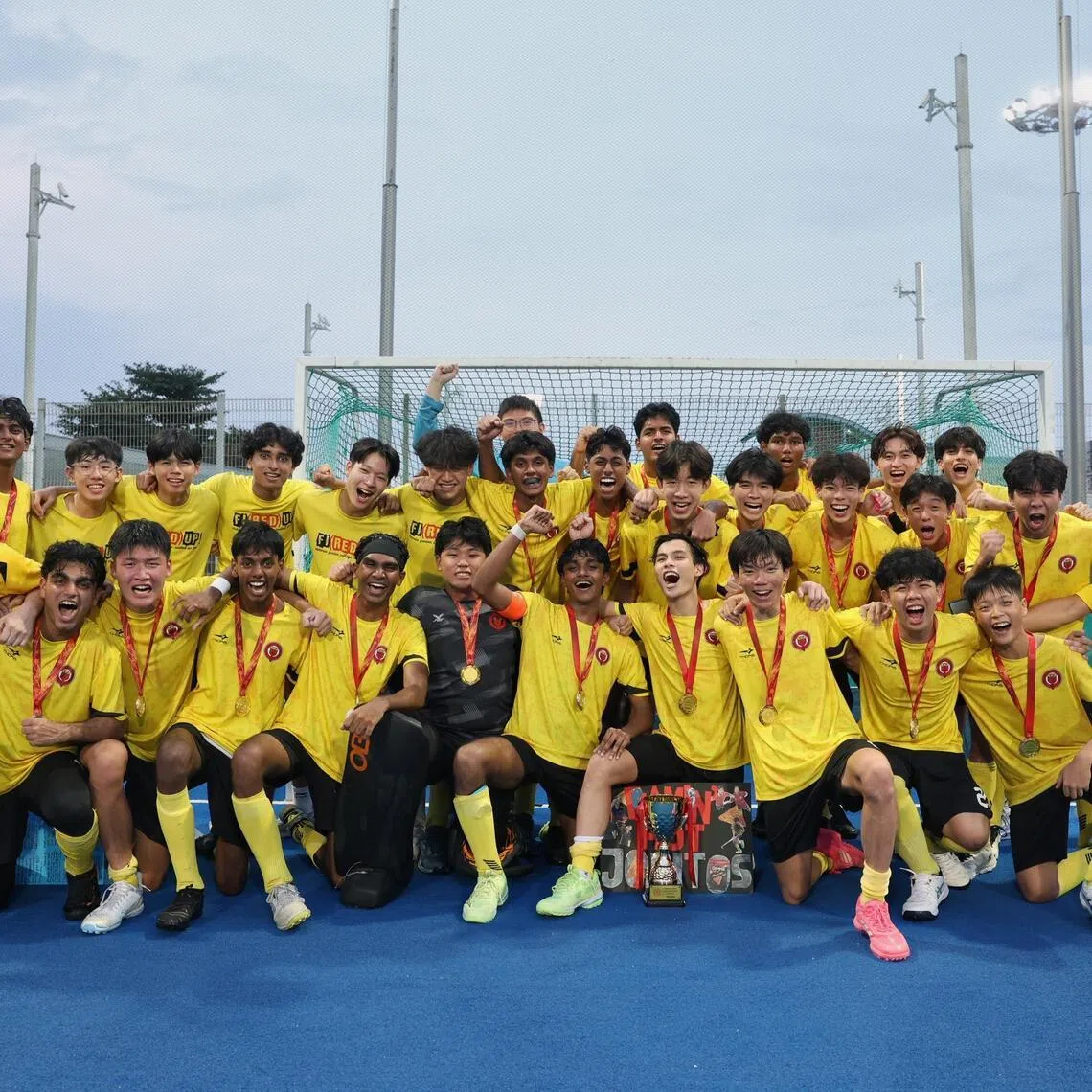 Players and staff from Victoria Junior College celebrate after winning the National School Games A Division Boys' Hockey Finals held at Sengkang Hockey Stadium on May 20, 2026.