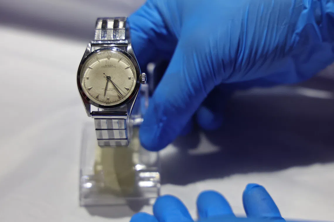An art handler preparing The Rolex Oyster Perpetual watch, gifted to Lee Kuan Yew by the Singapore Union of Postal and Telecommunications Clerical Workers (SUPTW) in 1953, for display in the gallery’s Towards a New Identity section on Aug 28, 2026.