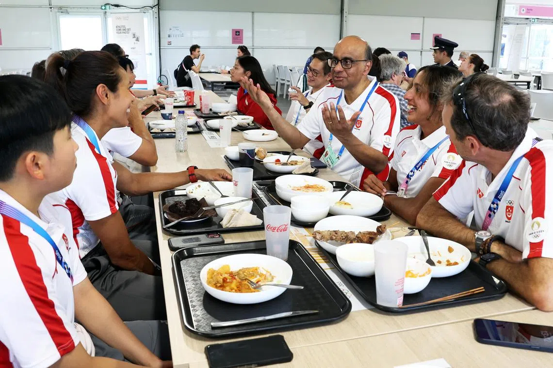 President of Singapore Tharman Shanmugaratnam dining with Singapore athletes at the Athletes Village at the Paris Olympics, including sprinter Shanti Pereira (on his left), fencer Kiria Tikanah (far right of him) and rower Saiyidah Aisyah and table tennis player Zhou Jingyi (diagonally opposite him).
