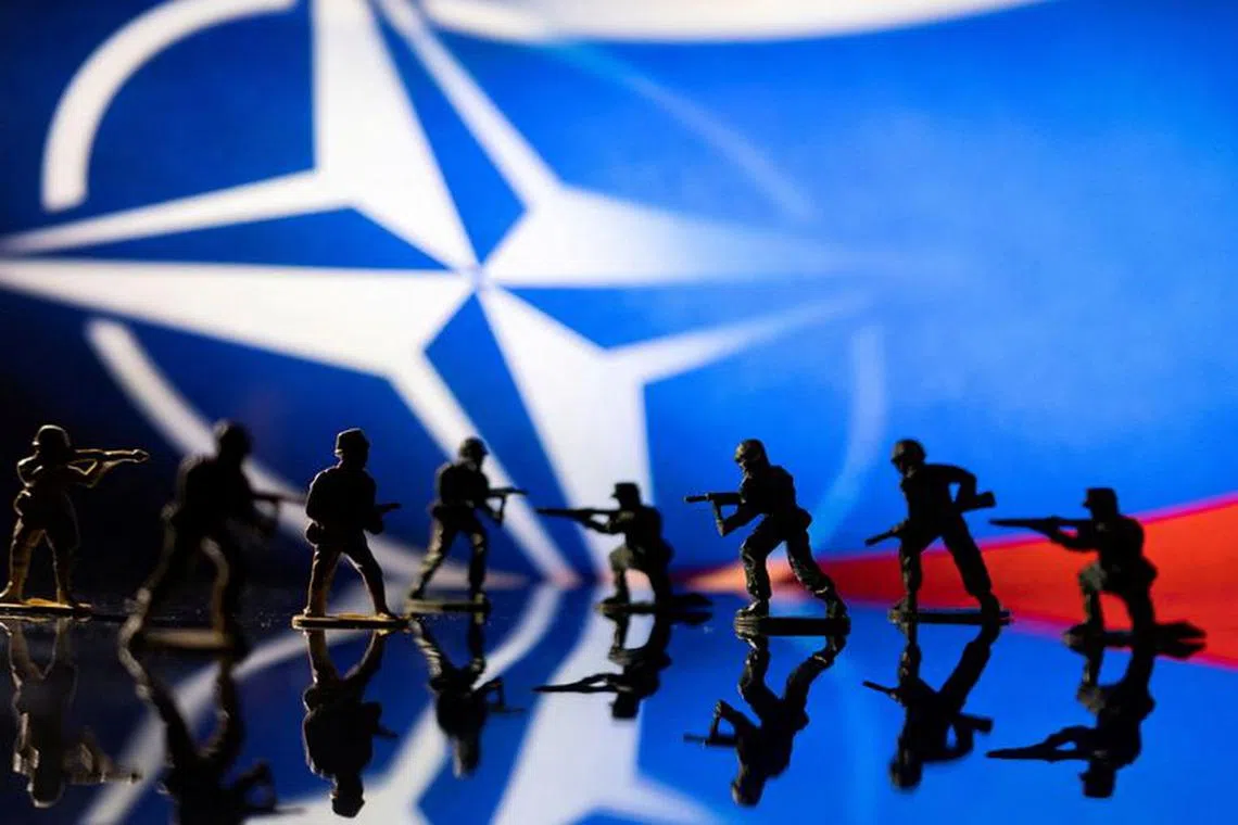FILE PHOTO: Army soldier figurines are displayed in front of the NATO logo and Russian flag colours background in this illustration taken, February 13, 2022. REUTERS/Dado Ruvic/Illustration/File Photo