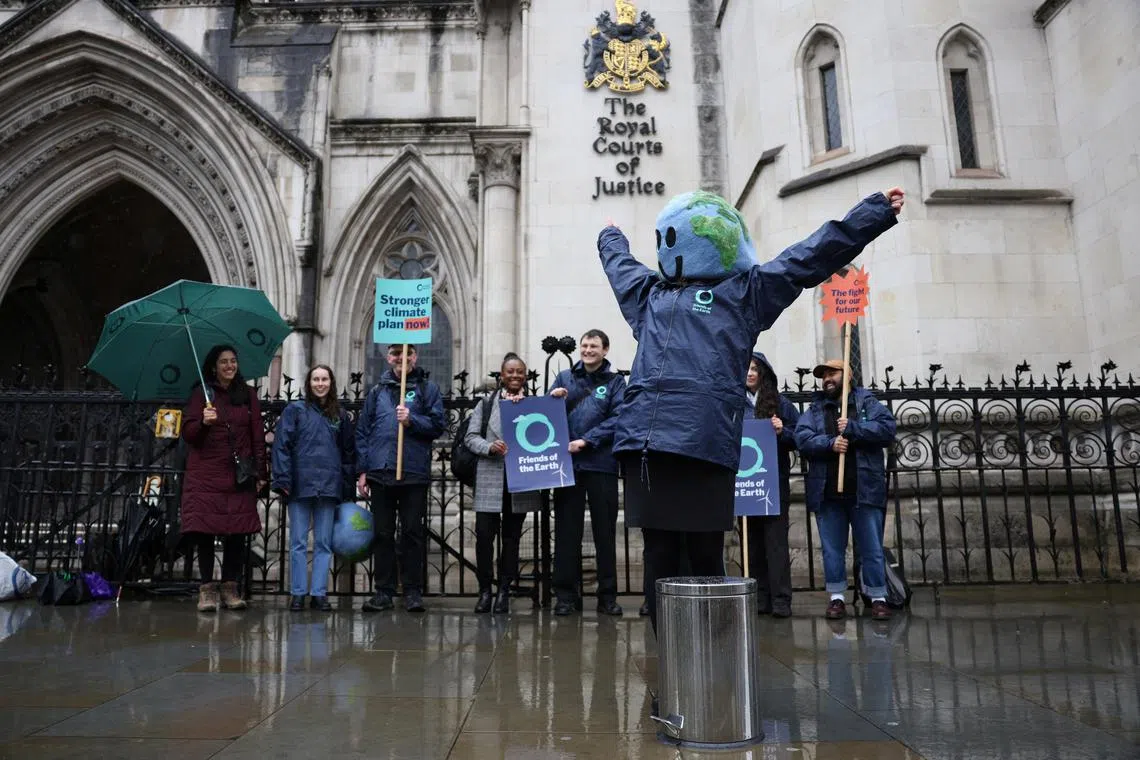 Environmental campaigners celebrate outside the High Court in London, Britain May 3, 2024. London's High Court has ruled that Britain's latest climate action plan is unlawful, in a legal challenge brought by Friends of the Earth, ClientEarth and the Good Law Project over Britain's new climate action plan. REUTERS/Hollie Adams