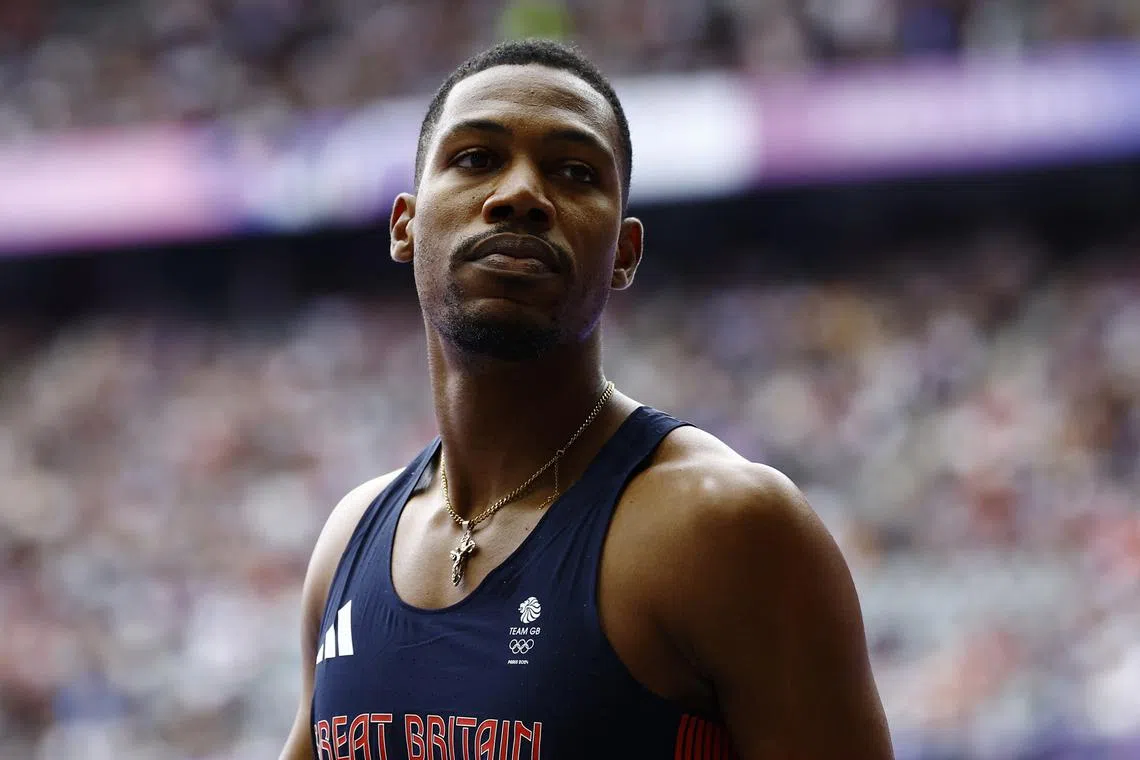 FILE PHOTO: Paris 2024 Olympics - Athletics - Men's 100m Round 1 - Stade de France, Saint-Denis, France - August 03, 2024. Zharnel Hughes of Britain reacts after heat 8. REUTERS/Sarah Meyssonnier/File Photo