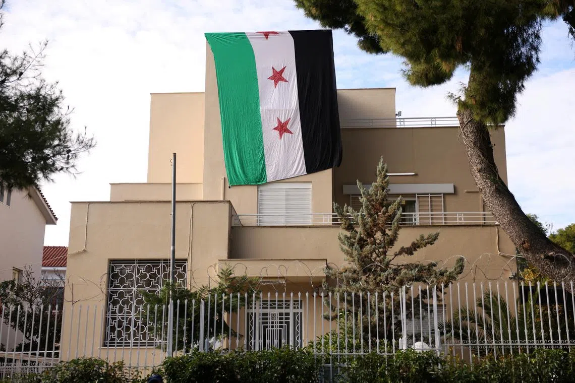 The Syrian opposition flag hangs at the Syrian embassy following an occupation of the embassy by Syrians living in Greece, after Syrian rebels announced that they have ousted President Bashar al-Assad in Syria, in Athens, Greece, December 8, 2024. REUTERS/Stelios Misinas