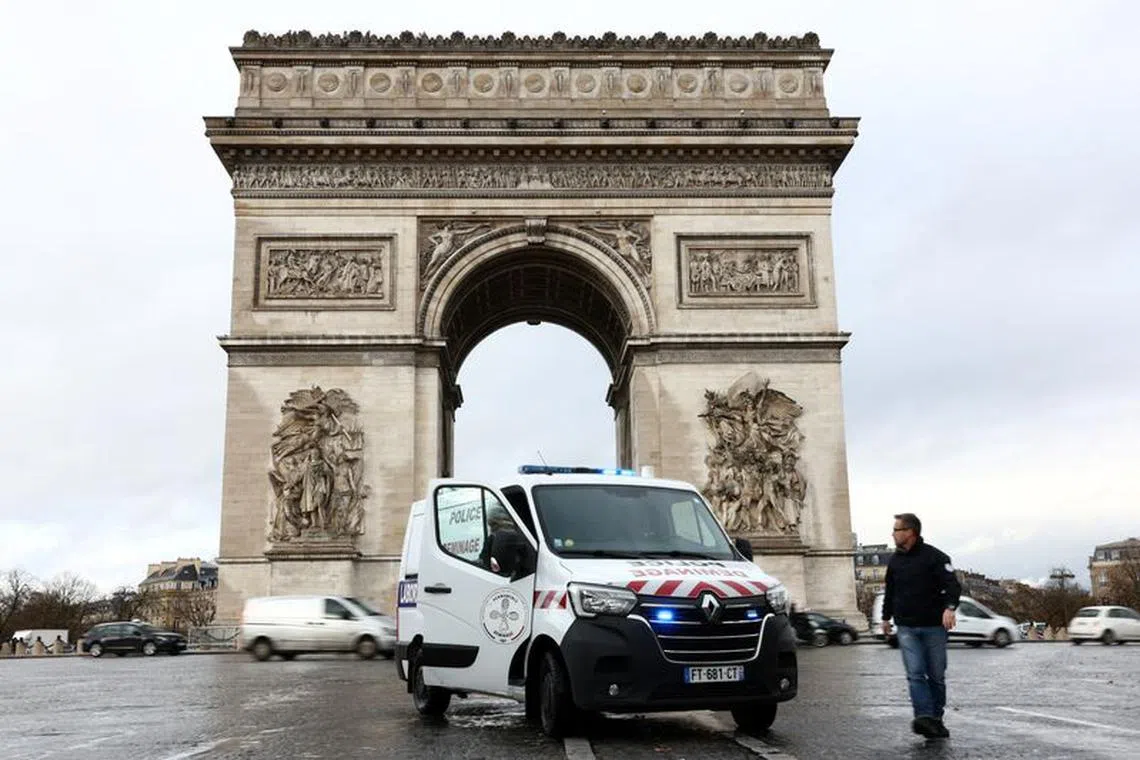 Members of the Paris police bomb squad intervene on the Champs Elysees avenue near the Arc de Triomphe in Paris as the bomb-disposal team gear up for heightened security operations for Paris 2024 Olympic and Paralympic Games, France, December 4, 2023. REUTERS/Stephanie Lecocq