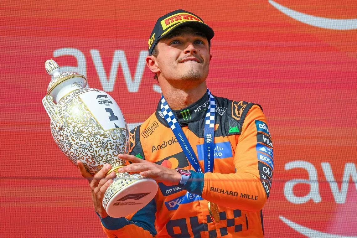 McLaren driver Lando Norris celebrating on the podium after winning the Hungarian Grand Prix on July 26.