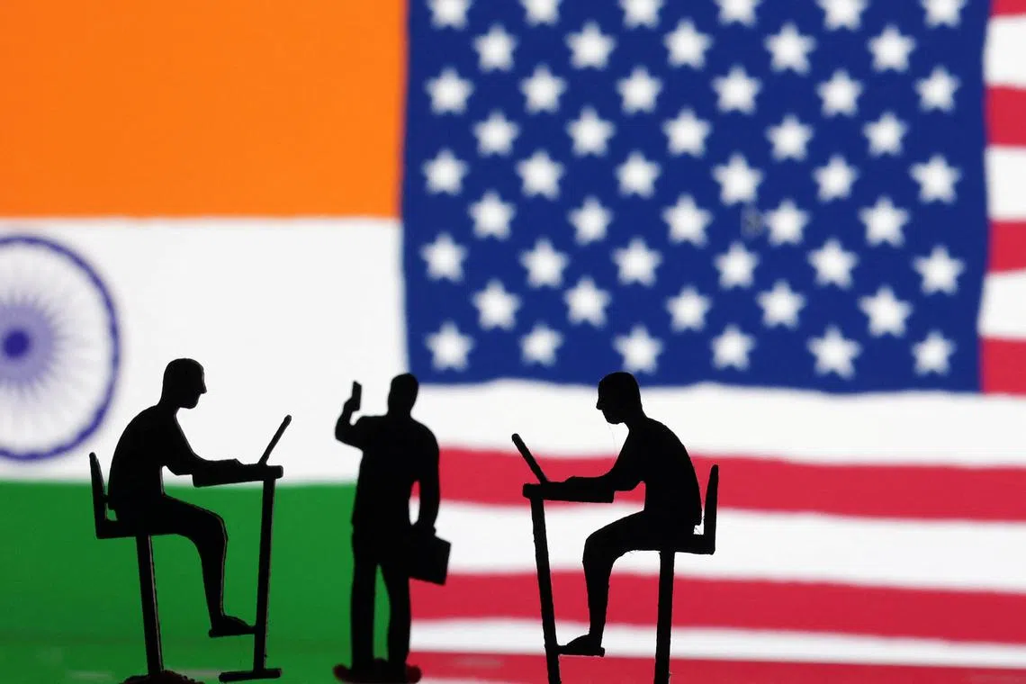 FILE PHOTO: The Indian flag, the U.S. flag and people miniatures, some with laptops, are seen in this illustration taken March 10, 2024. REUTERS/Dado Ruvic/Illustration/File Photo