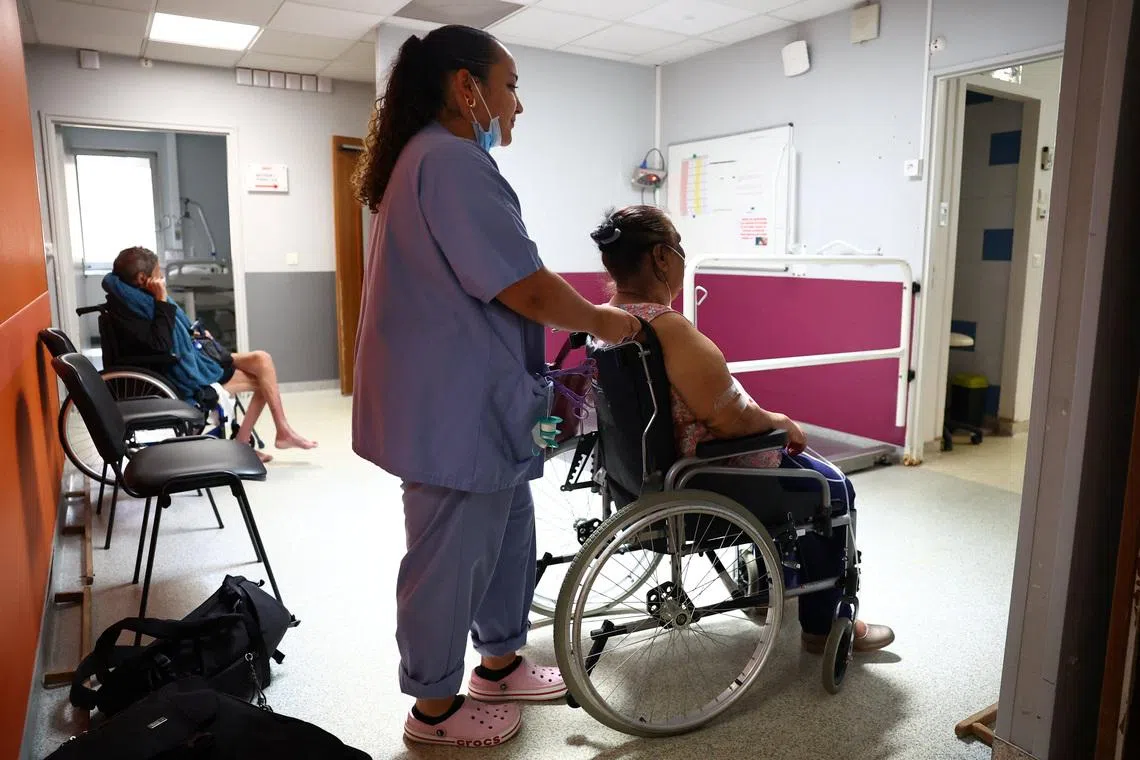 A nurse assists a patient at the Manhes Private Hospital in Fleury-Merogis near Paris during a heatwave affecting a majority of the country, France, June 25, 2026. REUTERS/Abdul Saboor