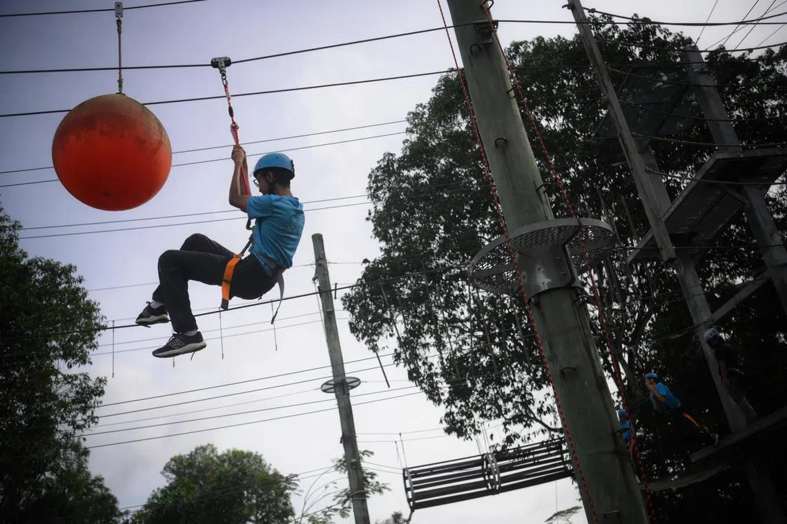 Student from Gan Eng Seng Secondary School manoeuvre his way around an obstacle course at the Jalan Bahtera Outdoor Adventure Learning Centre, on Feb 1, 2023.