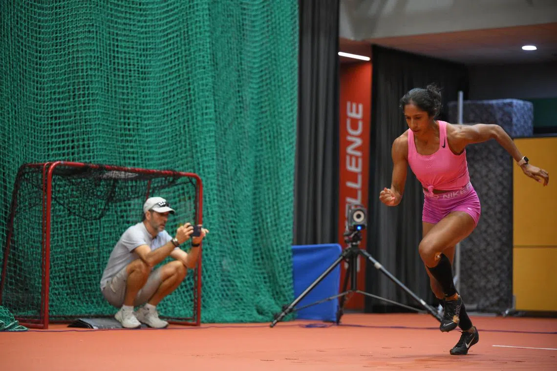 Coach Luis Cunha keeps a close eye on Shanti Pereira's technique during training. 